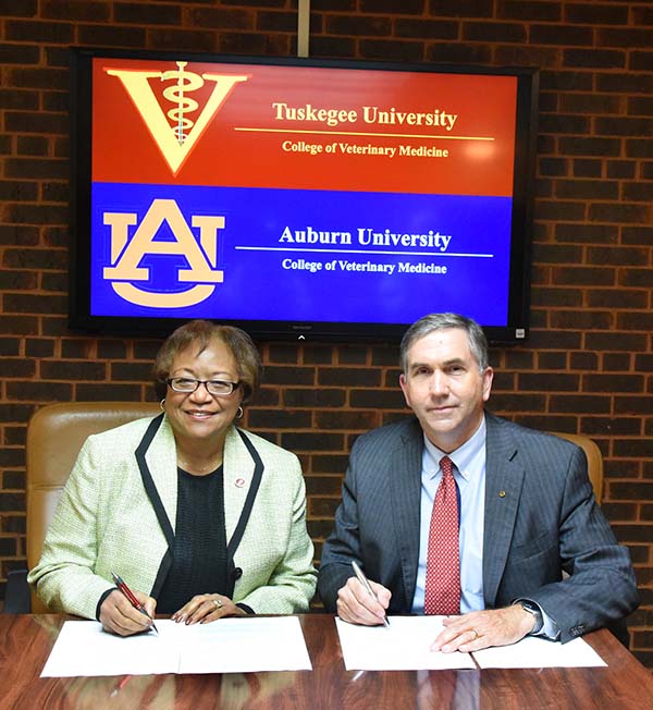 Dean Perry and Dean Johnson signing document