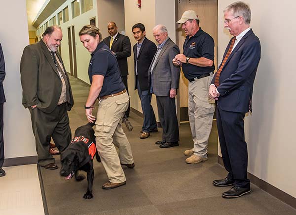 U.S. Attorney Jeff Sessions, center right, watches a demonstration of a detection dog Laura Reeder.