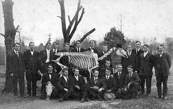 Dr. Cary and student pose with horse skeleton circa 1907