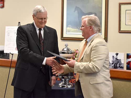 Dr. Jamie Bellah, head of the Department of Clinical Sciences, presents the retirement gift to Dr. Dillon.