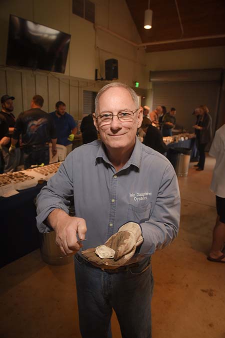 Duke holding open oyster