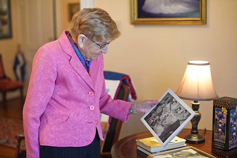 Dr. Pennings holding photo in her home