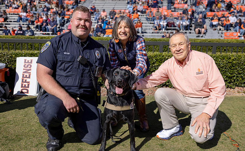 Officer Jason Bryan with K9 Ginger and Ginger and Walt Woltosz