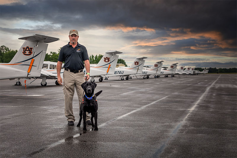 Black Lab with handler at airport
